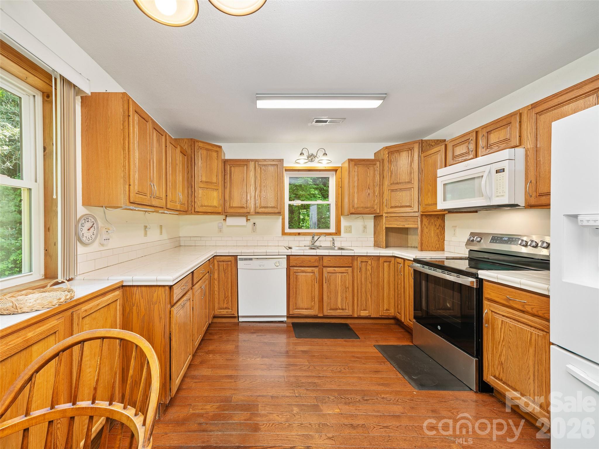 142 Wildflower Road Spruce Pine, NC 28777 - Photo 8 of 46 a kitchen with stainless steel appliances granite countertop a sink and wooden cabinets