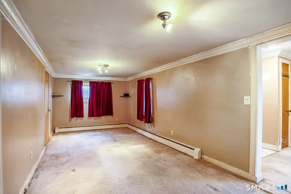 an empty room with windows and closet