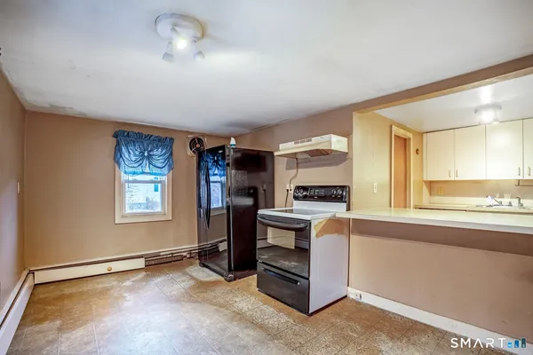 a view of workspace with window and cabinet