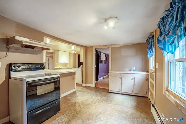 a kitchen with a stove and a refrigerator
