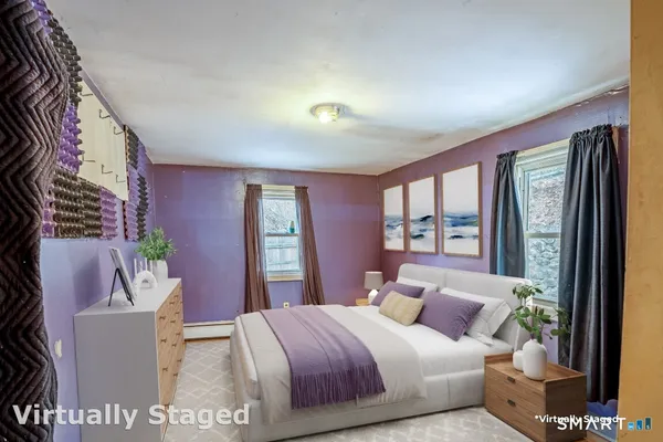 a bedroom with a bed and a window