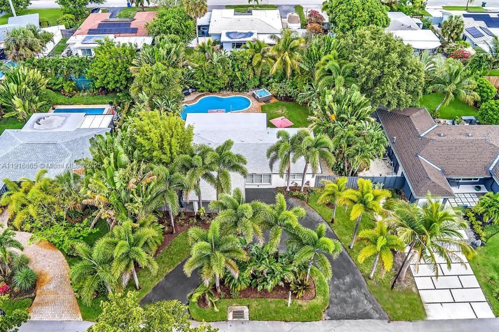 1577 Northeast 48th Court Oakland Park, FL 33334 - Photo 12 of 21 a view of a flower arrangement in backyard
