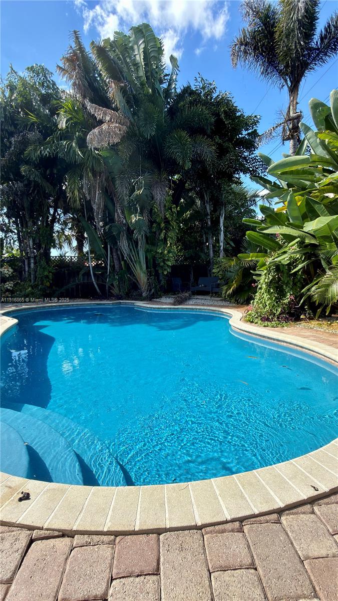 1577 Northeast 48th Court Oakland Park, FL 33334 - Photo 17 of 21 a view of a yard