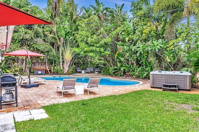 a view of a backyard with sitting area and a slide