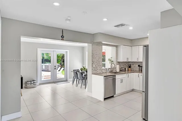 a kitchen with appliances cabinets and a table
