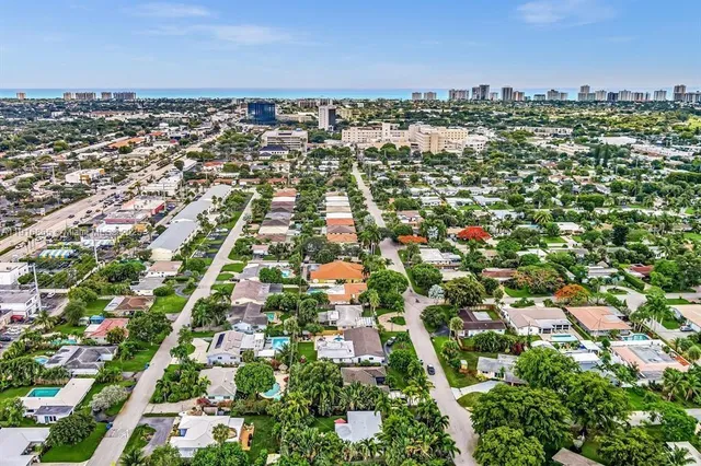 an aerial view of residential houses with city view