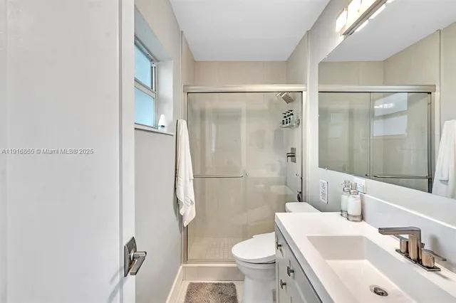 a bathroom with a sink toilet and shower