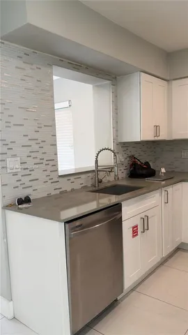 a kitchen with stainless steel appliances granite countertop a sink and cabinets