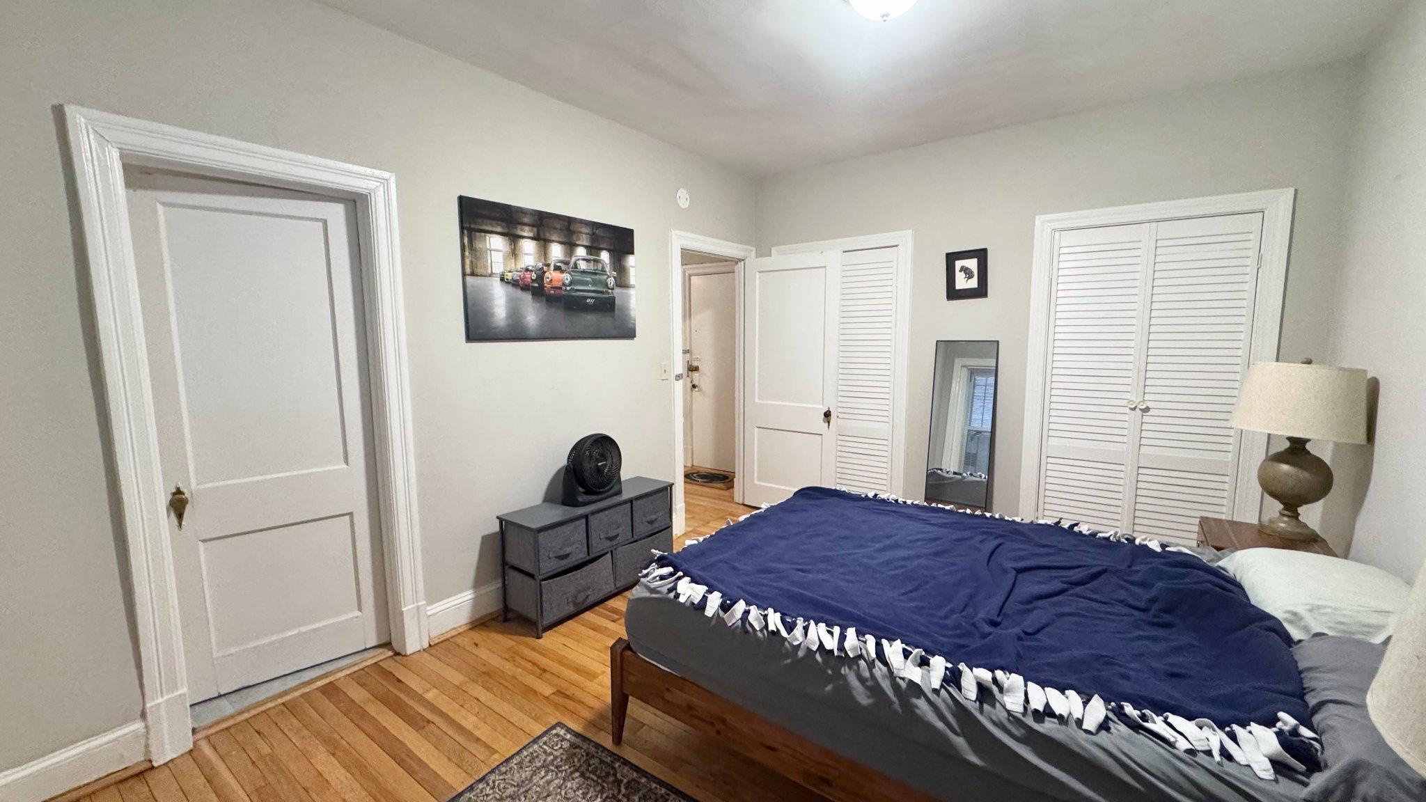 1954 Columbia Road Northwest, Unit 105 Washington, DC 20009 - Photo 10 of 12 a bedroom with a bed and a window