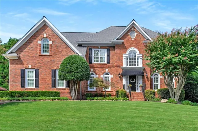 a front view of a house with a yard
