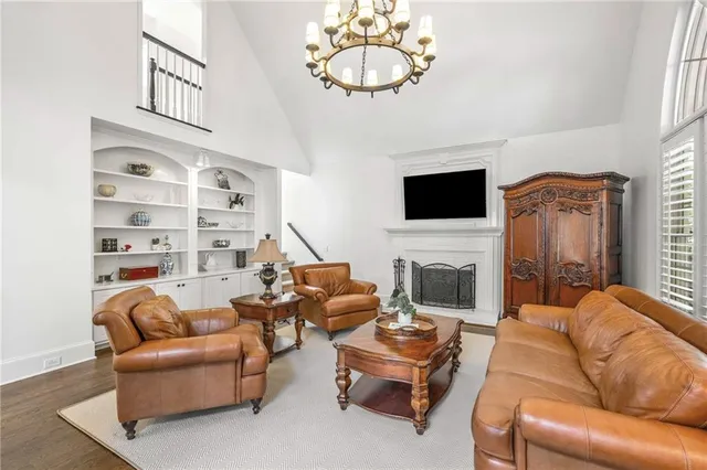 a view of a dining room with furniture a chandelier and wooden floor