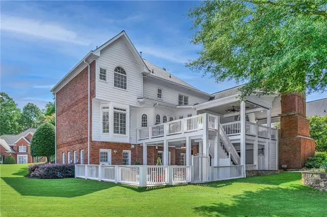 a view of a patio with couches table and chairs and potted plants