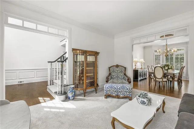 a spacious bedroom with a bed and a chandelier