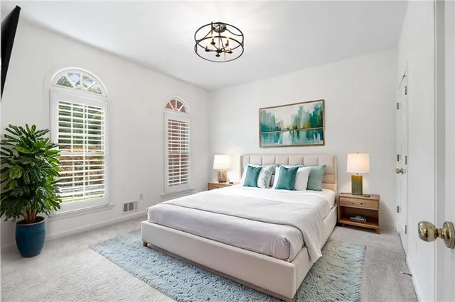 a bedroom with a large bed and a tv