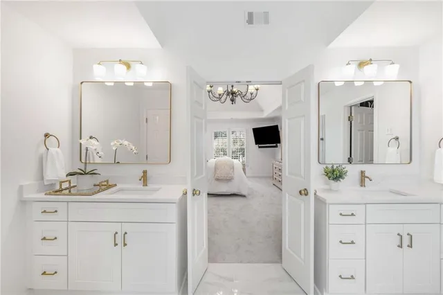 a bathroom with a sink double vanity and a mirror