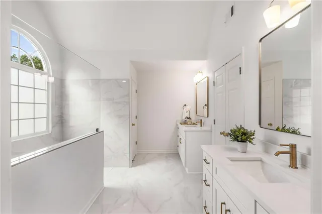 a spacious bedroom with a bed and a couch