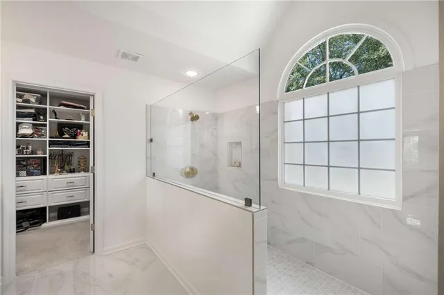 a bedroom with a bed and a potted plant