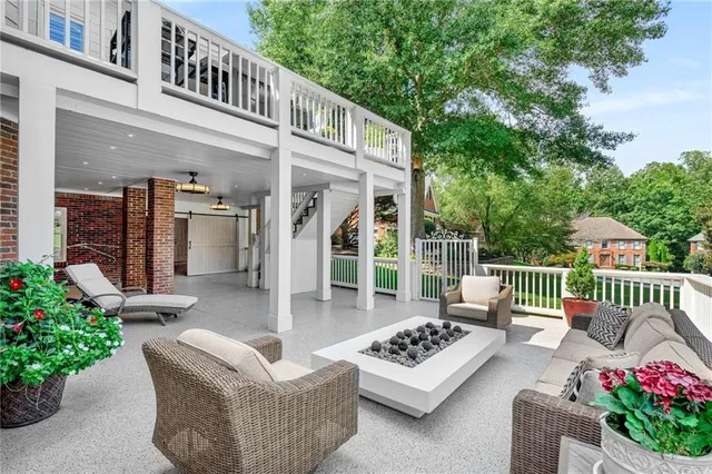 a outdoor space with patio the couches and a fireplace