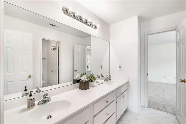 a spacious bedroom with a bed and large window