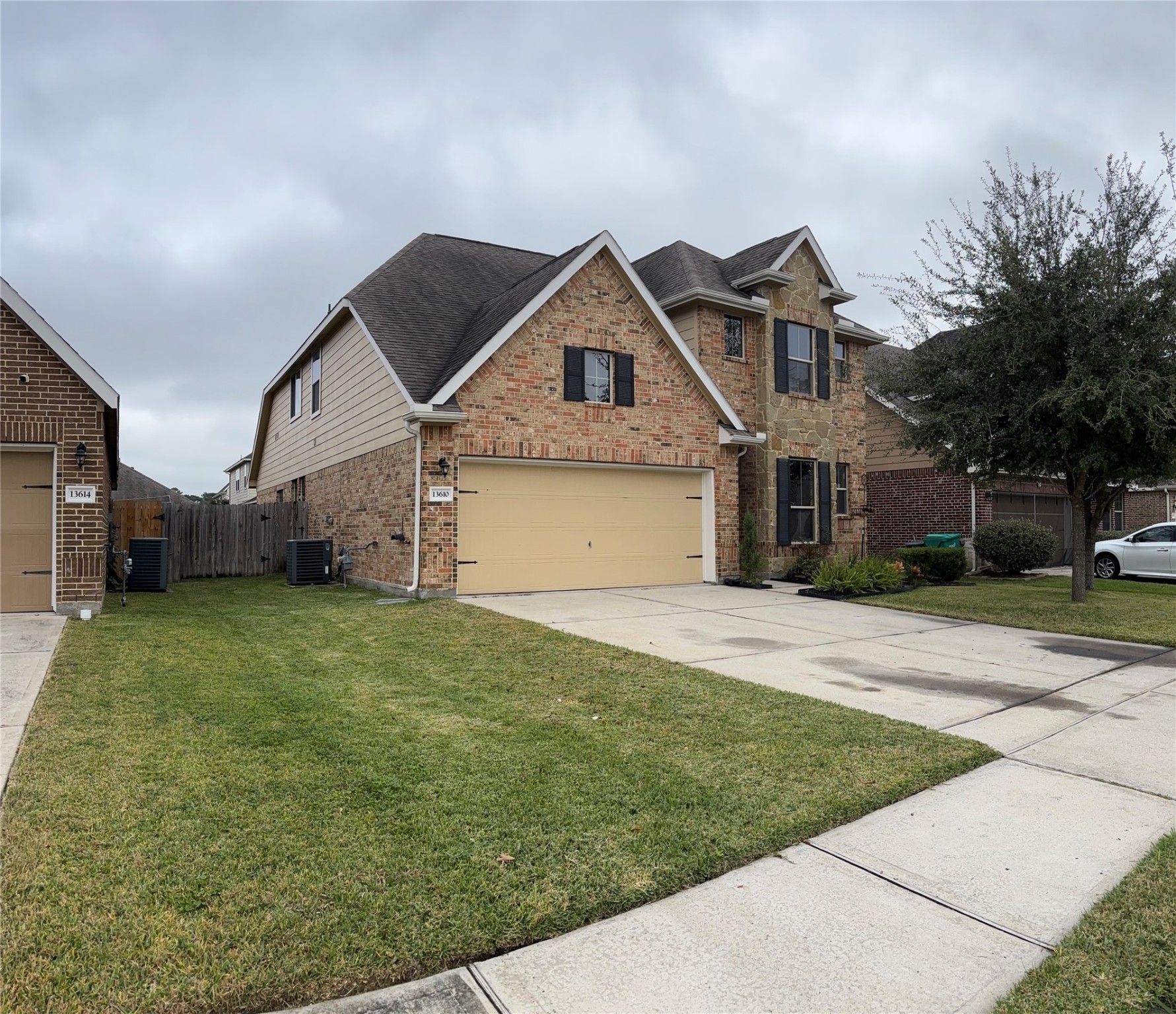 13610 Spectacled Bear Lane Crosby, TX 77532 - Photo 1 of 32 a front view of a house with a yard and garage