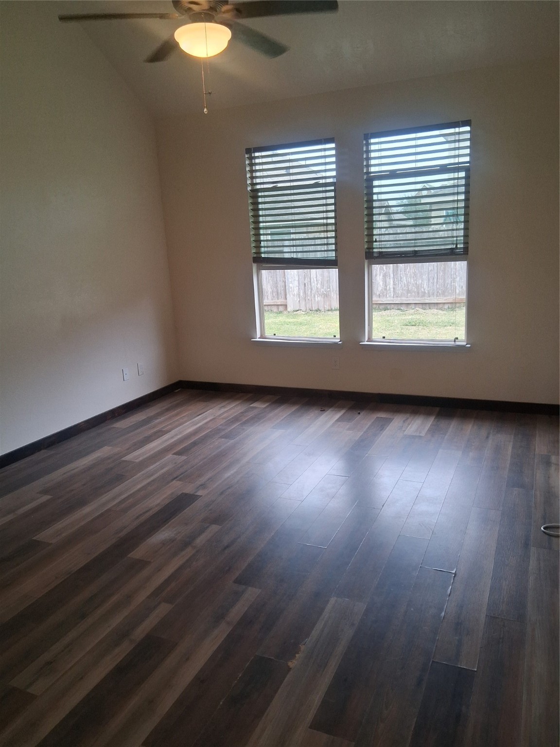 13610 Spectacled Bear Lane Crosby, TX 77532 - Photo 11 of 32 an empty room with wooden floor and windows