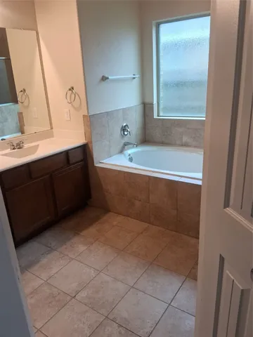 a bathroom with a bathtub and a sink