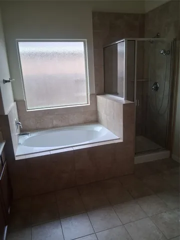 a bathroom with a bathtub and a shower