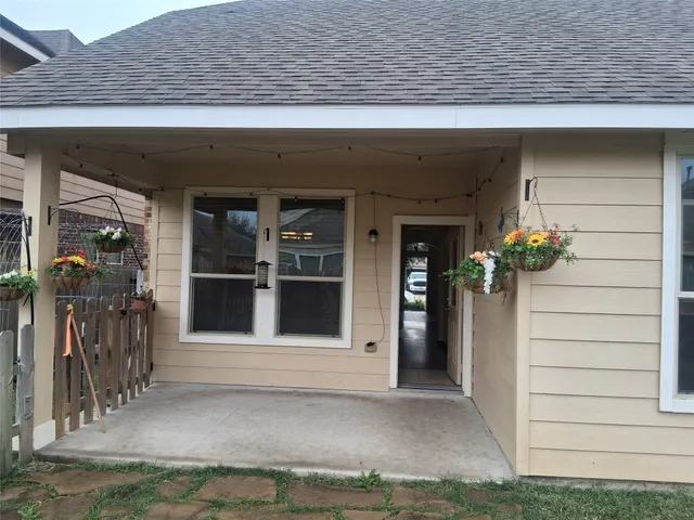 a view of front door and potted plants