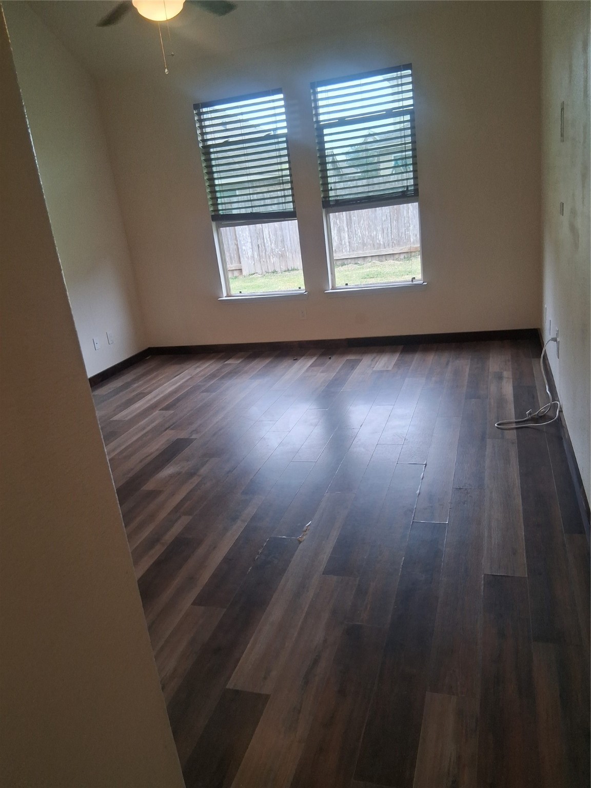 13610 Spectacled Bear Lane Crosby, TX 77532 - Photo 9 of 32 an empty room with wooden floor and windows