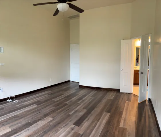 a view of an empty room and wooden floor
