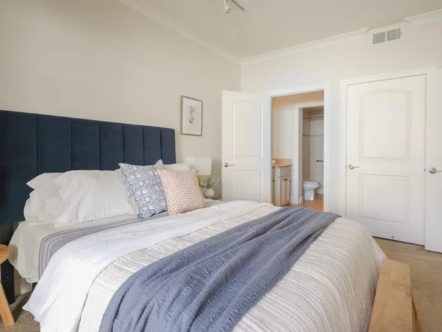 a large bed in a white room