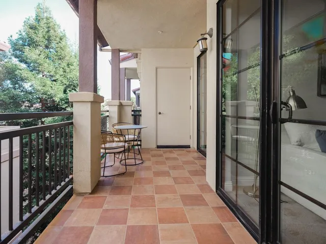 a view of a balcony with chair and front door