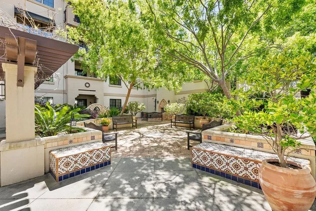 a view of backyard with outdoor seating and trees