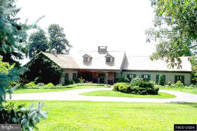6129 Hoff Road Spring Grove, PA 17362 - Photo 1 of 4 a front view of a house with a yard and potted plants