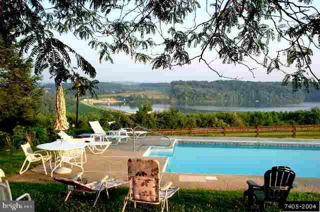6129 Hoff Road Spring Grove, PA 17362 - Photo 4 of 4 a view of a lake with couches and city view