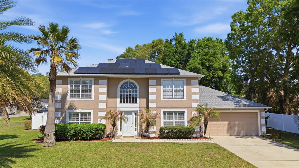 4517 Southeast 28th Street Ocala, FL 34480 - Photo 1 of 43 a front view of a house with a yard