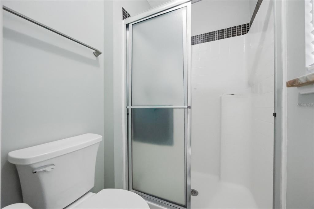 4517 Southeast 28th Street Ocala, FL 34480 - Photo 22 of 43 a white toilet sitting next to a shower