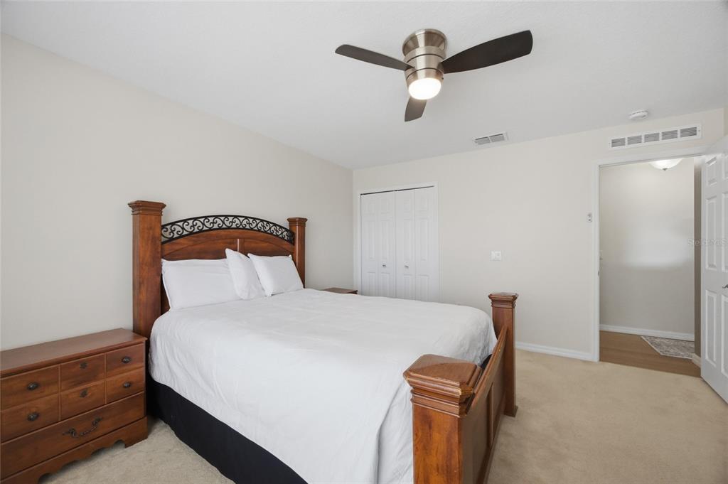 4517 Southeast 28th Street Ocala, FL 34480 - Photo 24 of 43 a bedroom with a bed and a ceiling fan