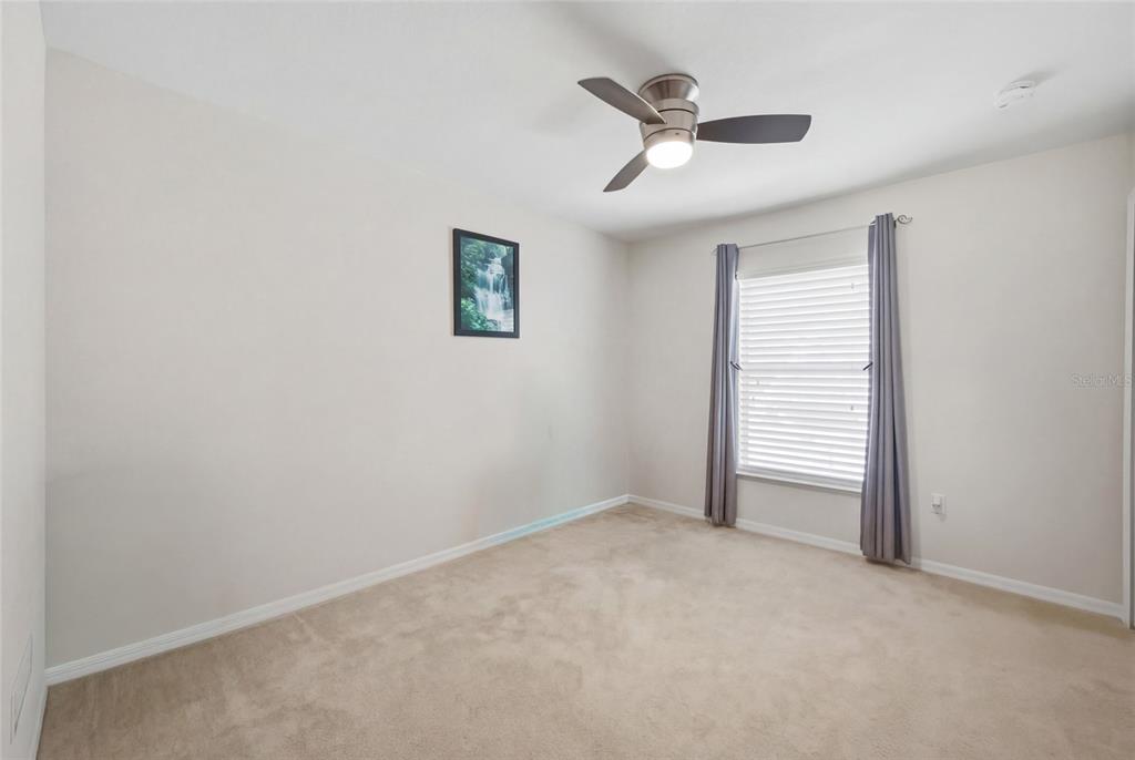 4517 Southeast 28th Street Ocala, FL 34480 - Photo 25 of 43 an empty room with closet and ceiling fan