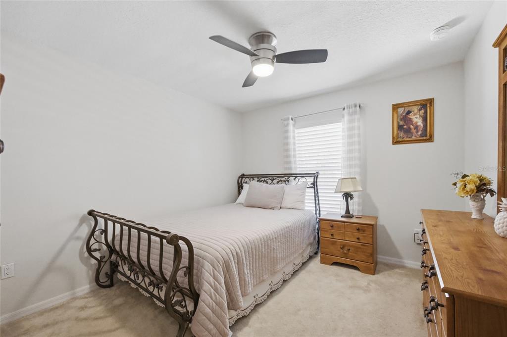 4517 Southeast 28th Street Ocala, FL 34480 - Photo 27 of 43 a bedroom with a bed and a chandelier