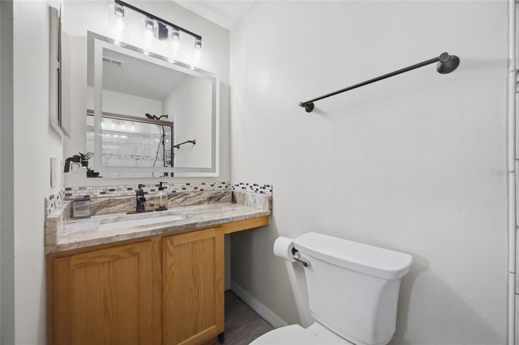 4517 Southeast 28th Street Ocala, FL 34480 - Photo 29 of 43 a bathroom with a toilet sink and mirror