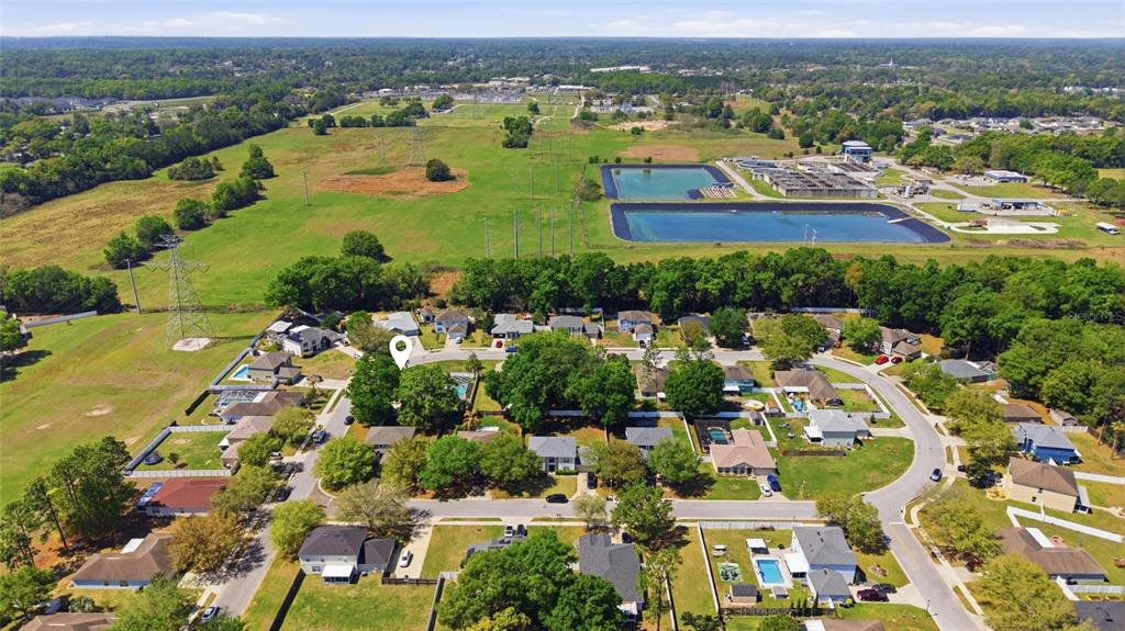 4517 Southeast 28th Street Ocala, FL 34480 - Photo 42 of 43 an aerial view of residential houses with outdoor space and trees