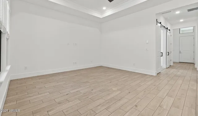 a large kitchen with a large counter top a sink stainless steel appliances and cabinets