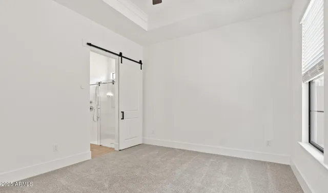 an empty room with windows and closet