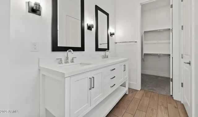 a bathroom with a double vanity sink and mirror