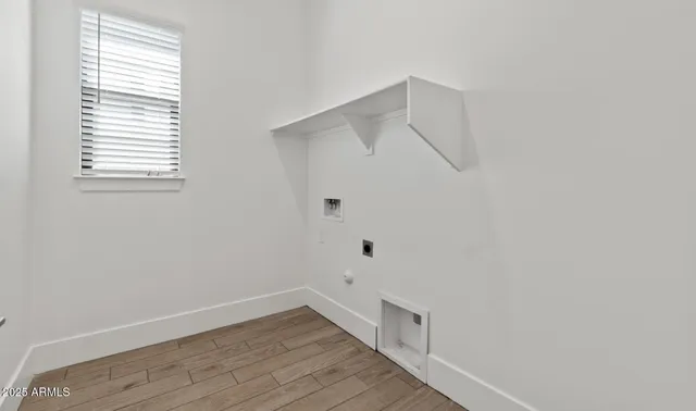 a view of a room with wooden floor and white walls