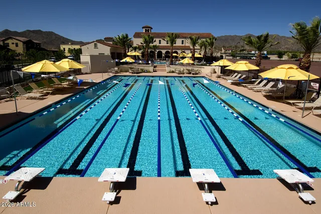 a view of a swimming pool and trees in the background