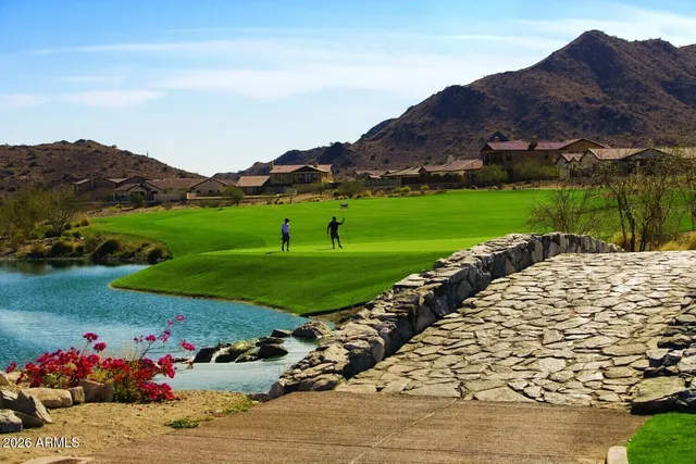 a view of a backyard with table and chairs under an umbrella