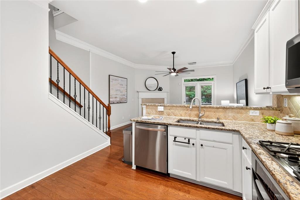 1982 Cobblestone Circle Northeast Brookhaven, GA 30319 - Photo 12 of 51 a kitchen with stainless steel appliances granite countertop a sink and stove