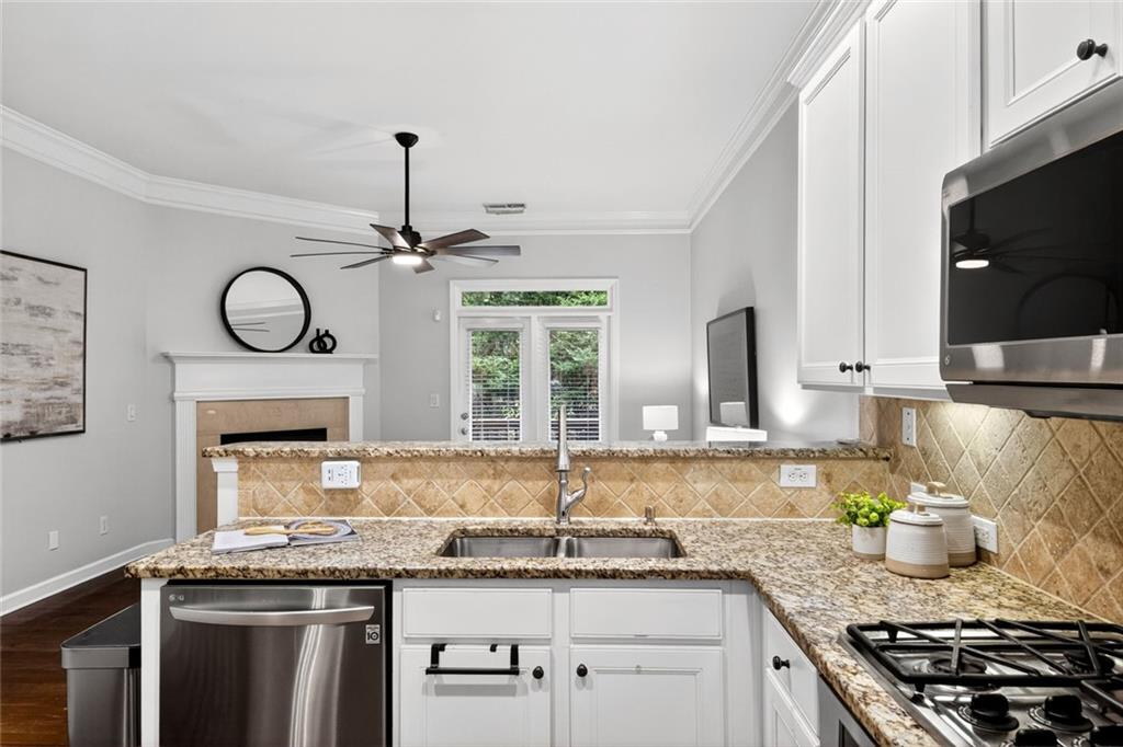 1982 Cobblestone Circle Northeast Brookhaven, GA 30319 - Photo 15 of 51 a kitchen with granite countertop stainless steel appliances a sink stove and cabinets